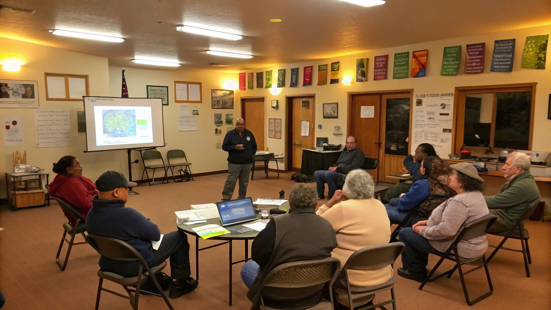 A lively neighborhood watch meeting focused on garage security. The scene is set in a cozy community center room with warm lighting and a circular arrangement of chairs. Diverse group of adults - men 