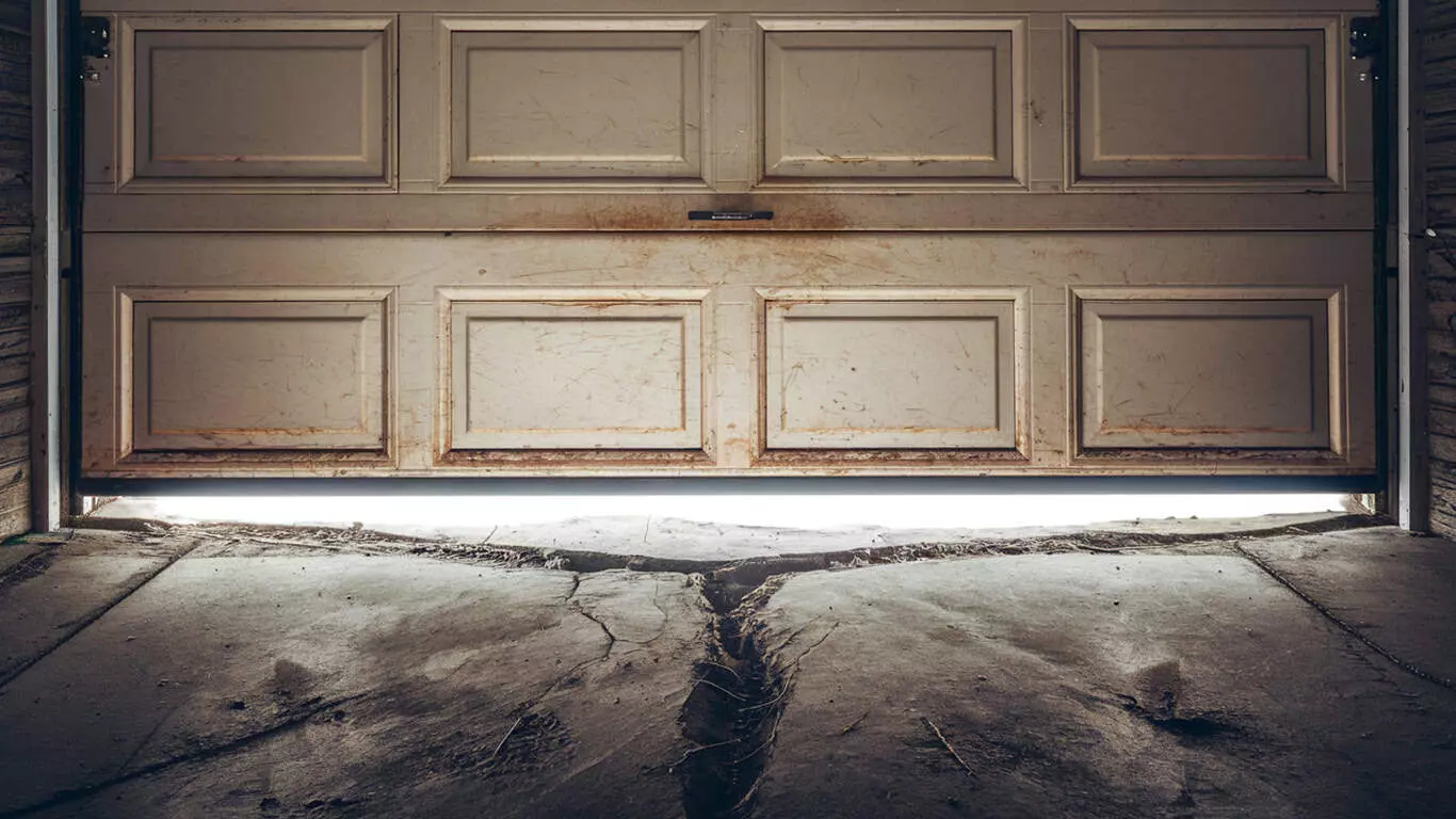 Close-up Photo of a Worn Garage Door Weather Seal with Ice