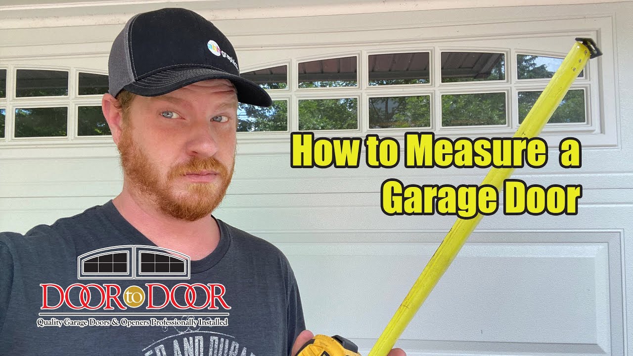 Professional installer measuring garage door opening with tape measure