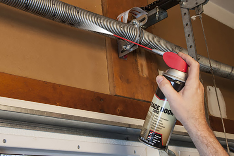 step-by-step photos cleaning lubricating garage door tracks