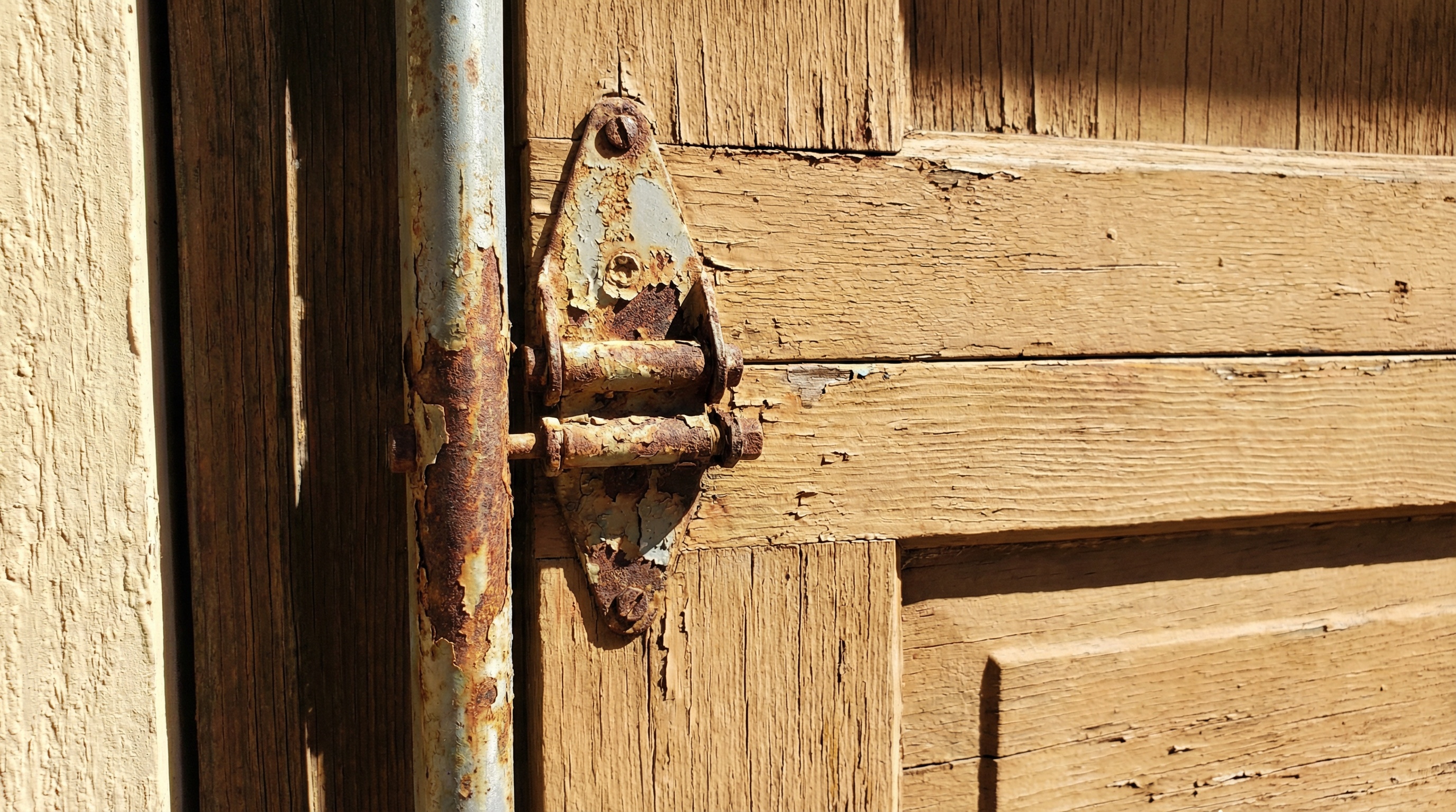 Weather-damaged garage door components showing rust and wear from Wisconsin climate