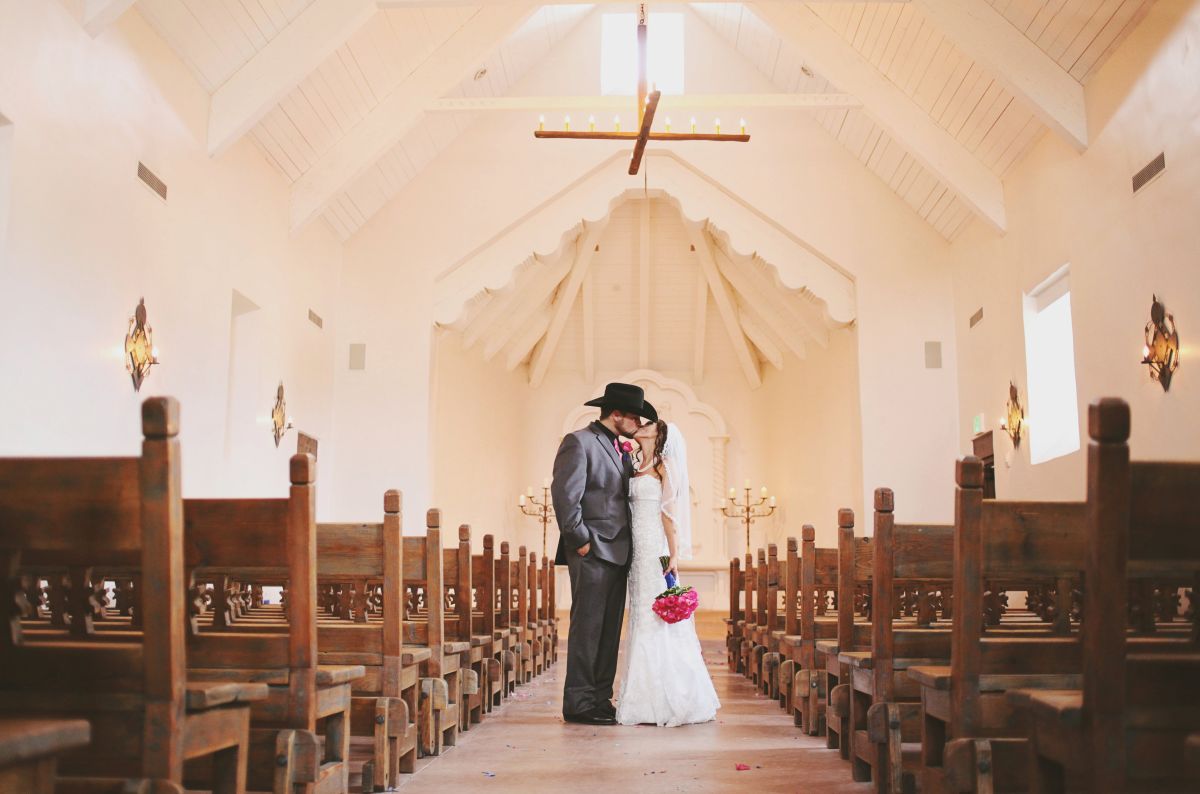 Bride and Groom inside the romantic San Isidro de Capilla wedding chapel