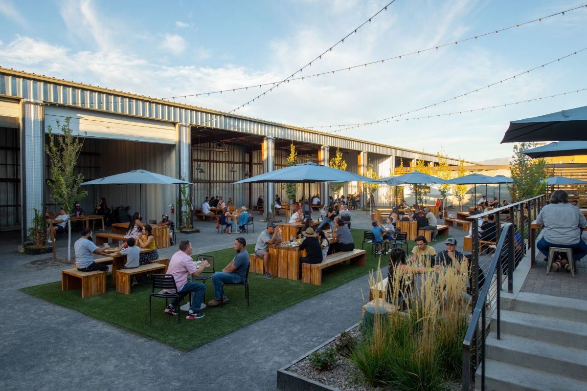 The Yard at Sawmill Market outdoor space with people sitting at tables