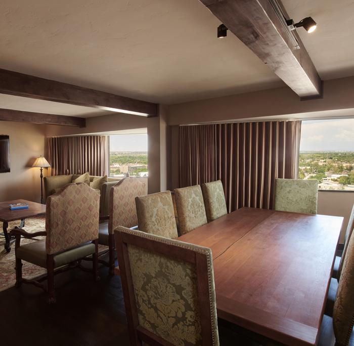 Presidential Suite living room with dining table and additional 