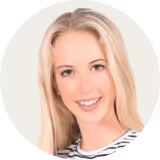 Smiling woman with long blonde hair wearing a striped top.