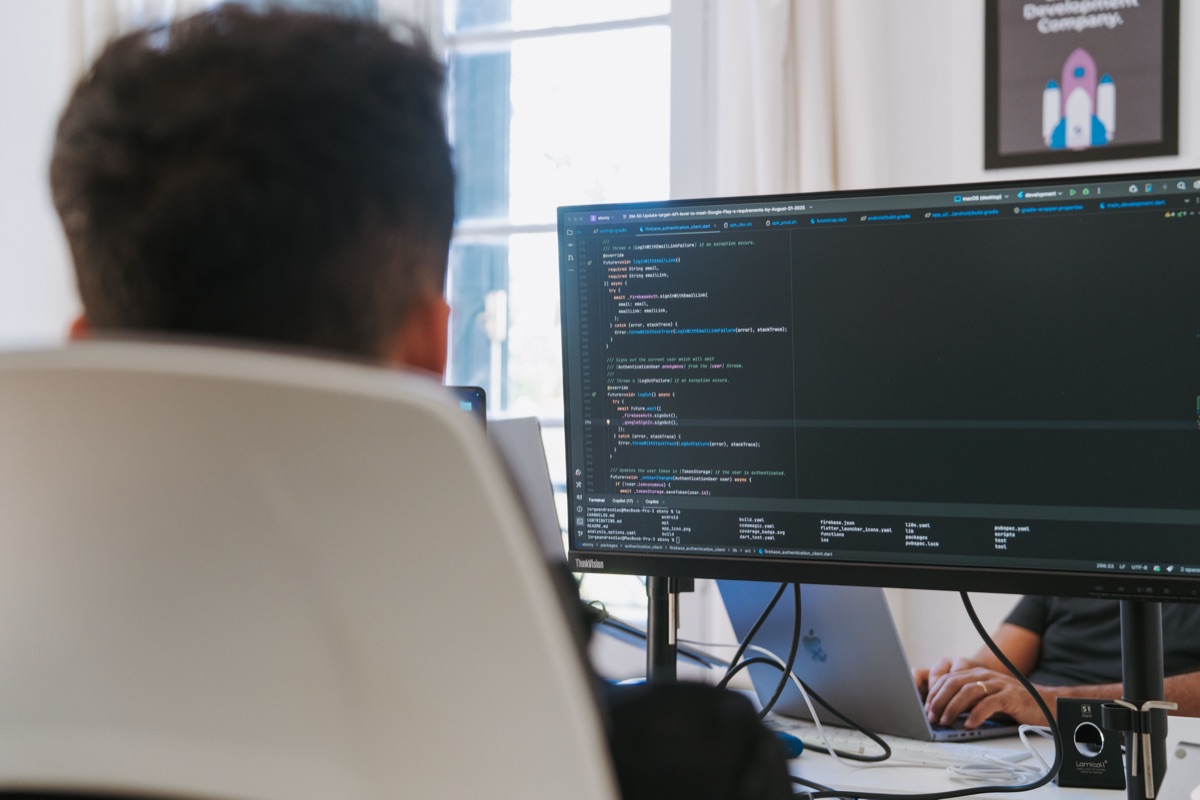 A Somnio engineer working on code at a dual monitor workstation