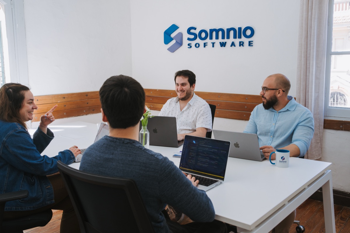 Somnio team members reviewing product work together in a meeting room