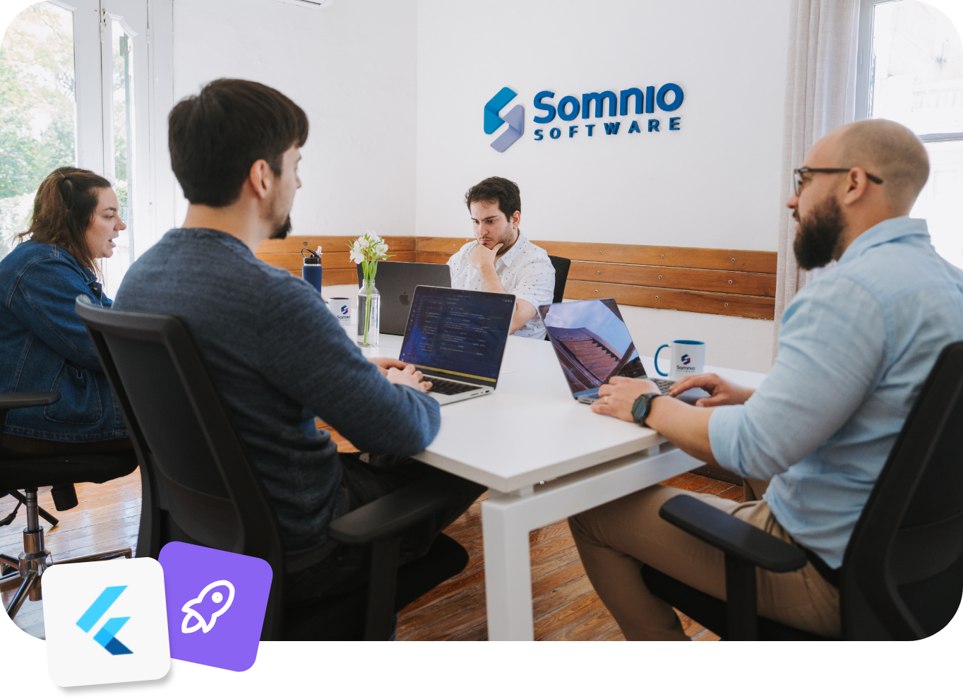 Somnio engineers working together at the office, with the Flutter logo