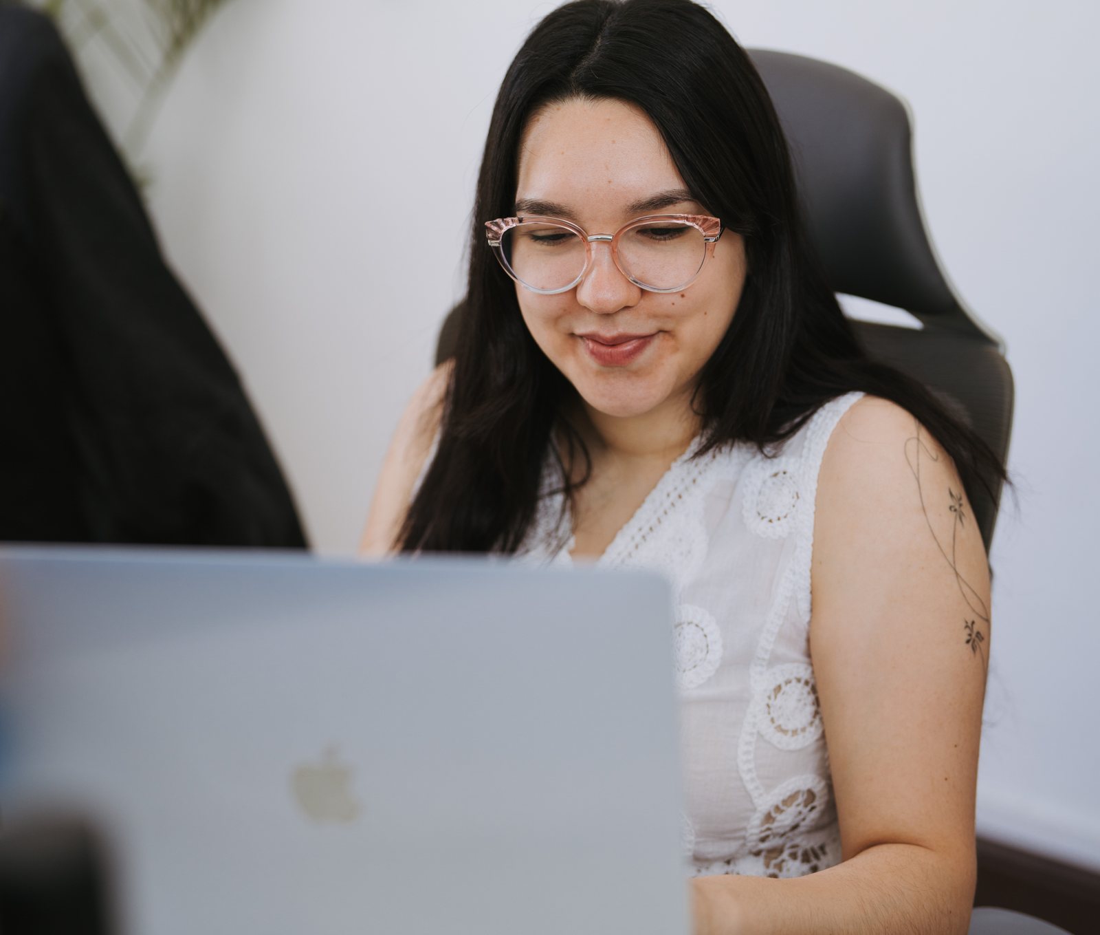 Somnio team member smiling while working on a laptop