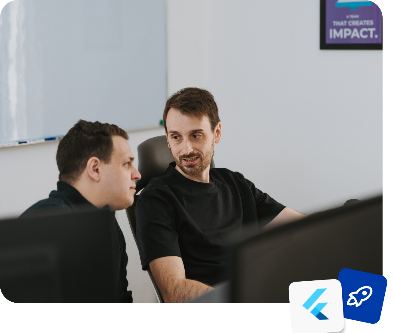 Two Somnio engineers reviewing work together at their desks