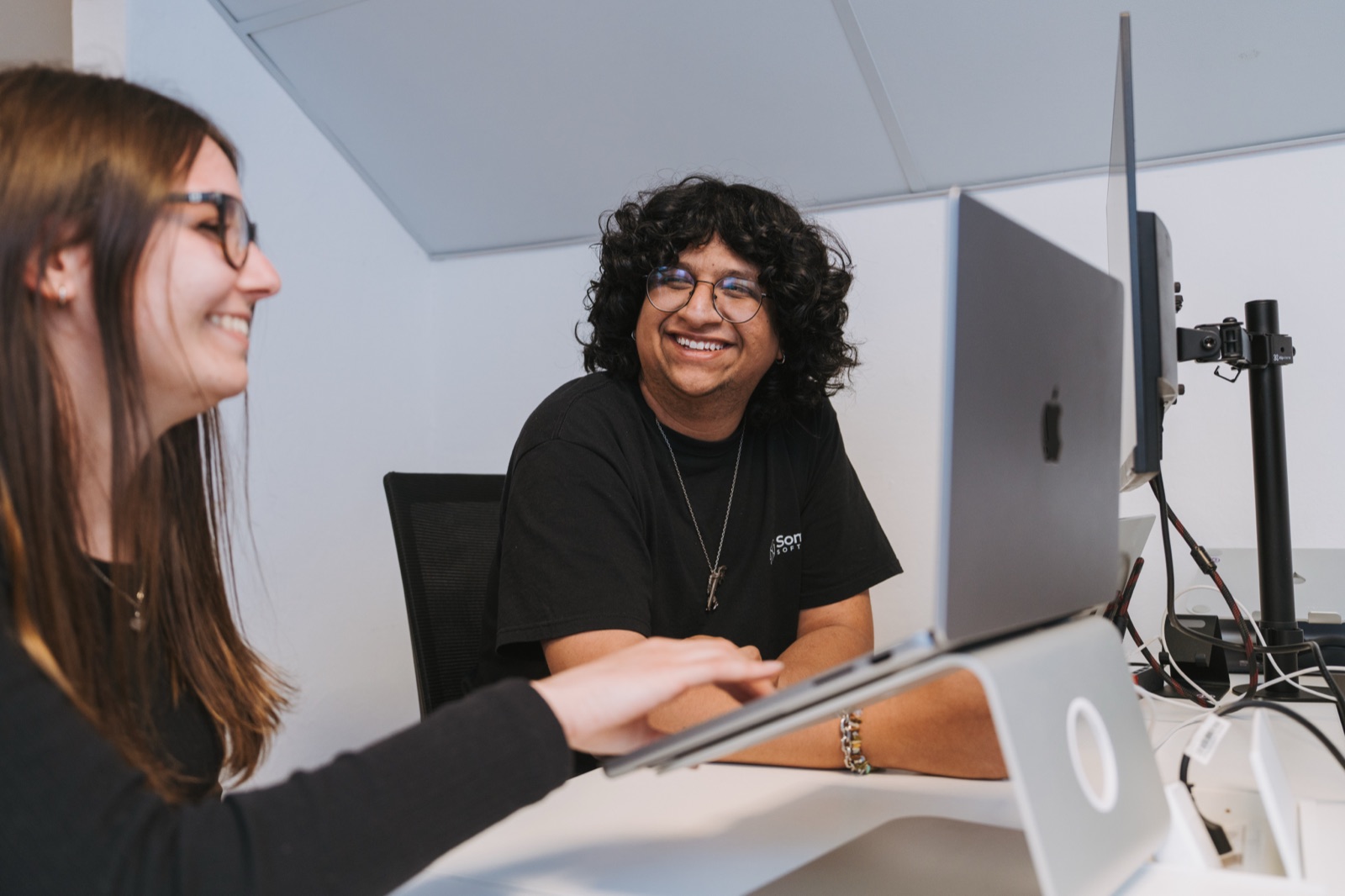 Two Somnio engineers laughing together at a desk