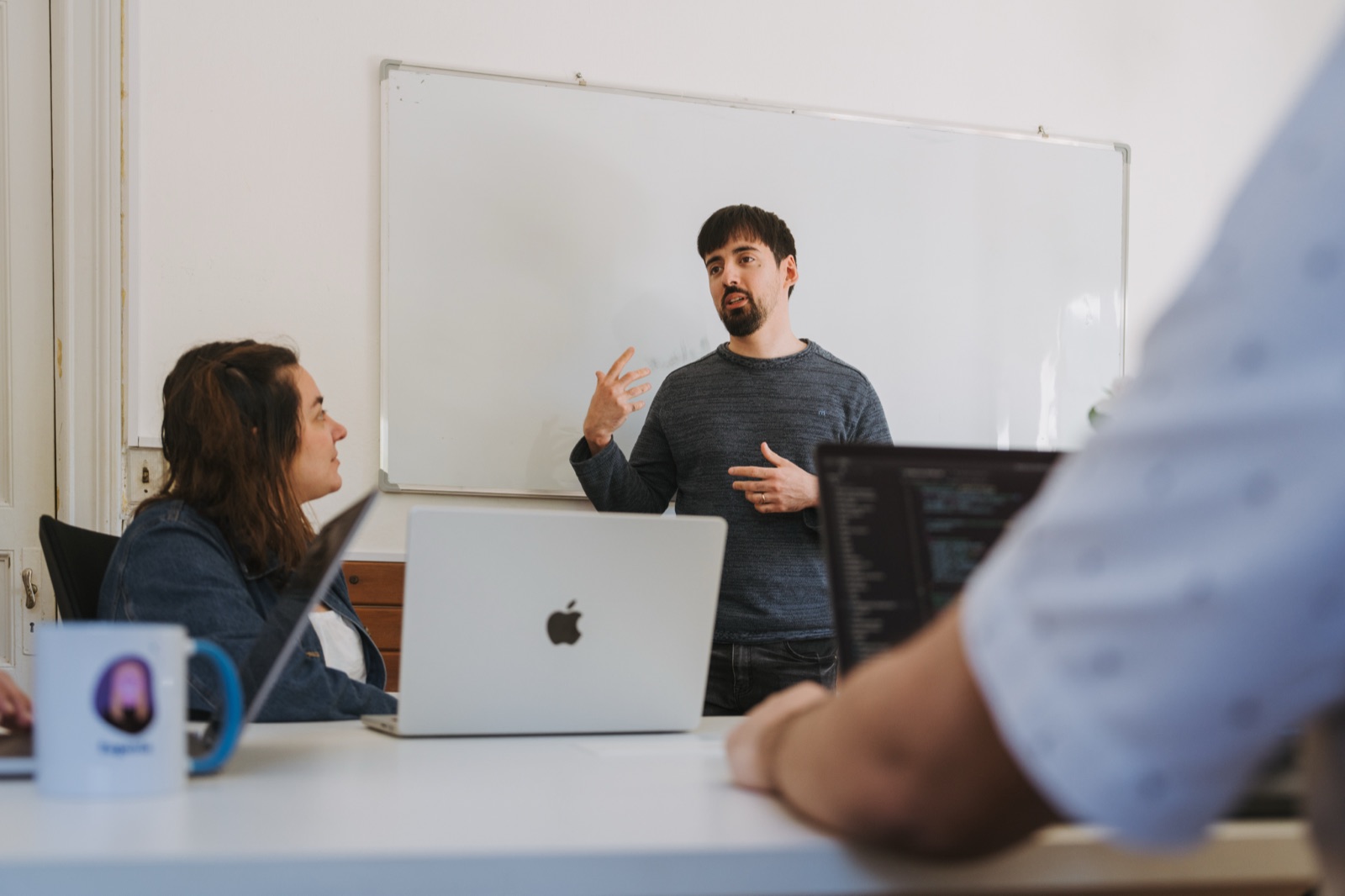 A Somnio engineer presenting at a whiteboard to the team