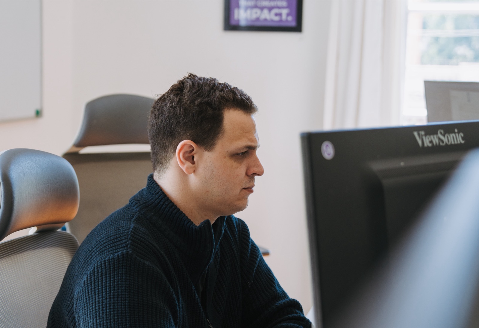 A Somnio engineer focused on a monitor