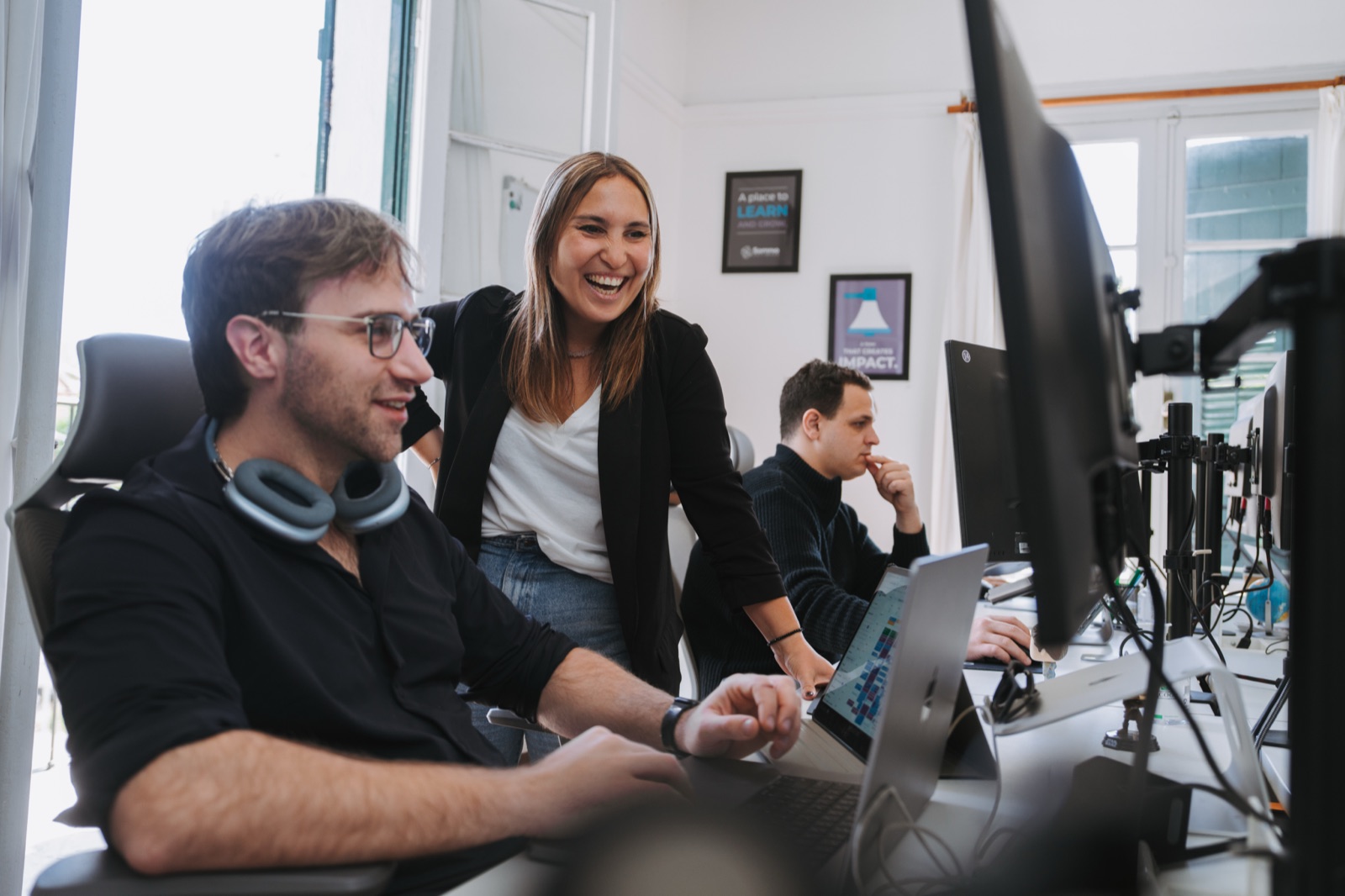 Somnio teammates smiling at a screen together