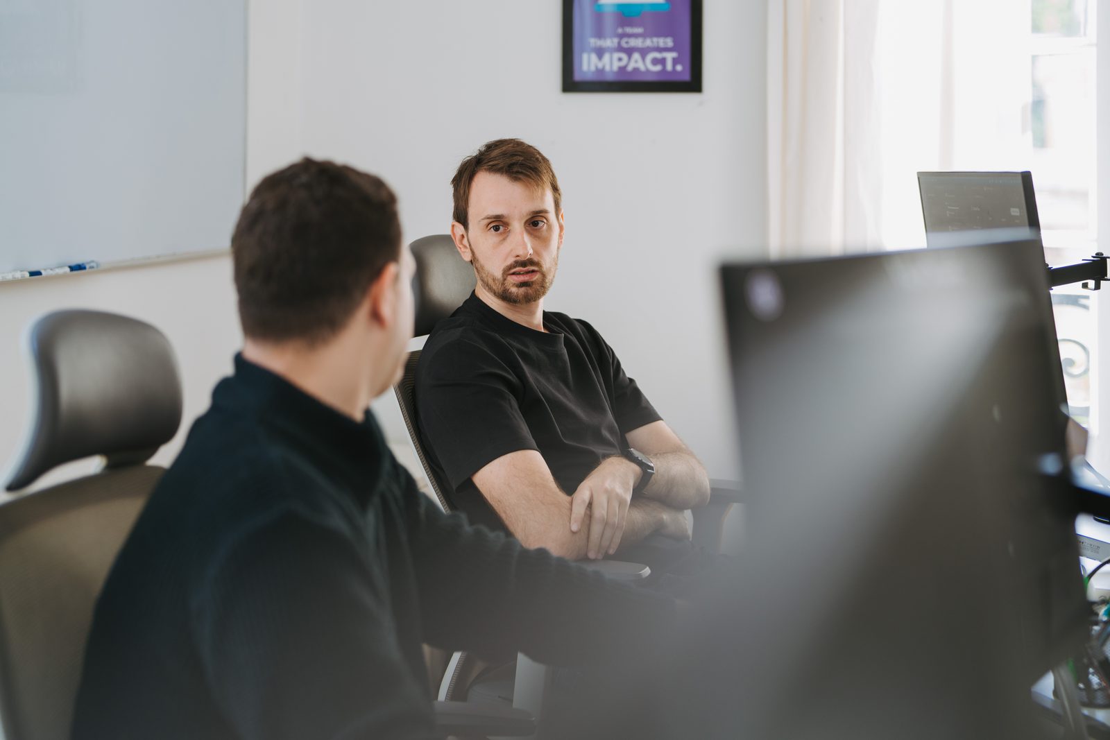 Two Somnio engineers reviewing code together at their desks