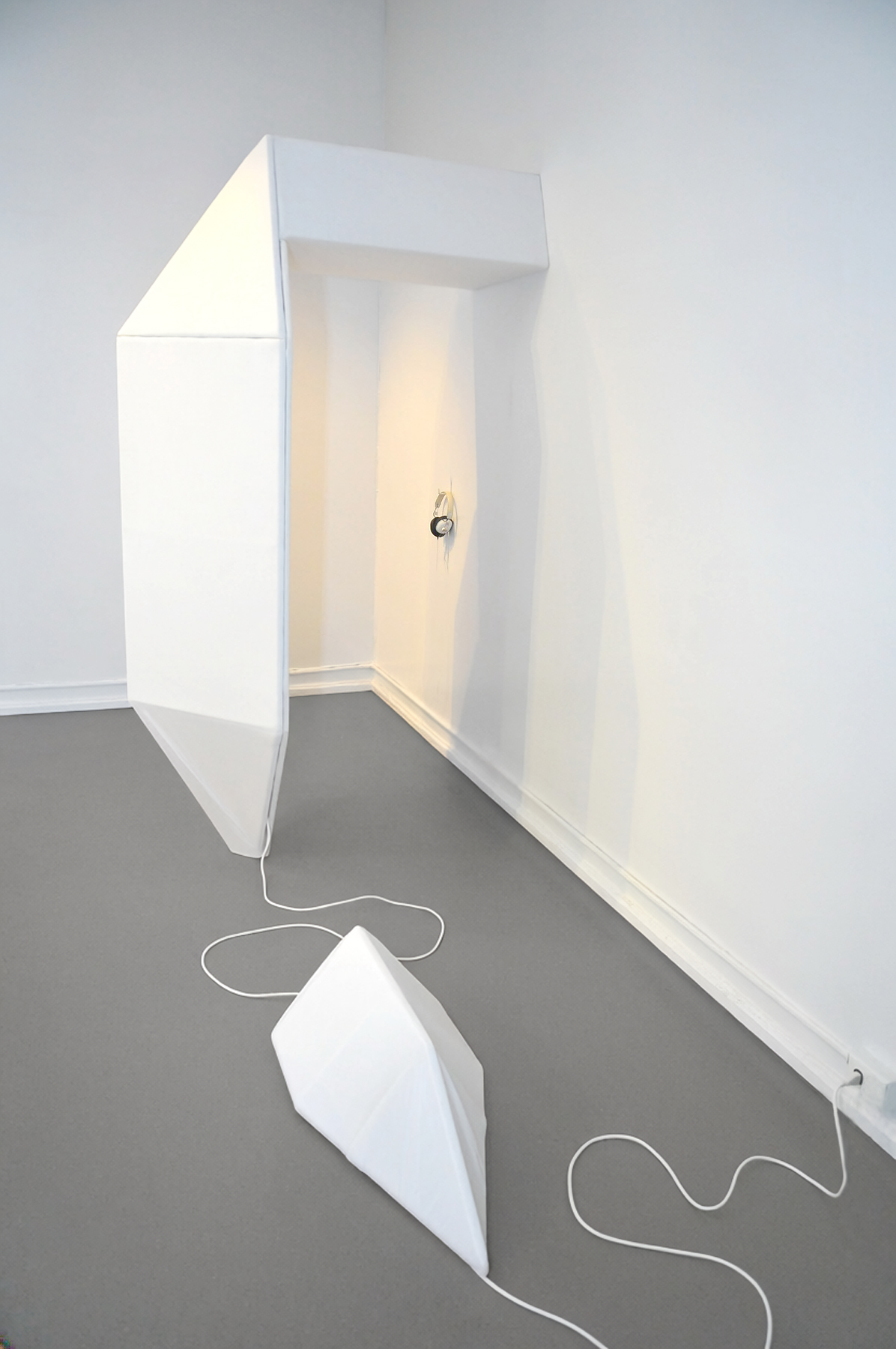 An immersive sculpture by artist Ryan Hackett titled Monarch Isolation Booth, shown empty.