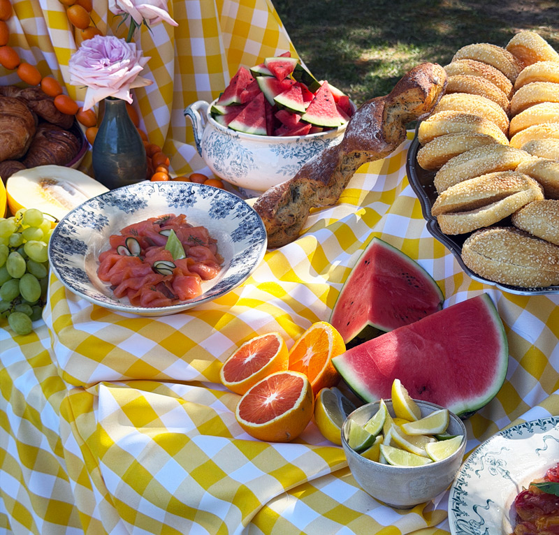 Buffet brunch coloré avec saumon, fruits frais, pains et agrumes préparé par La Dame Bleue