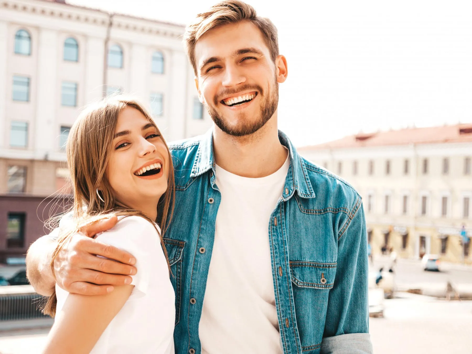 A man with his arm around his partner