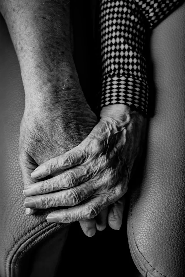 Two old hands holding one another