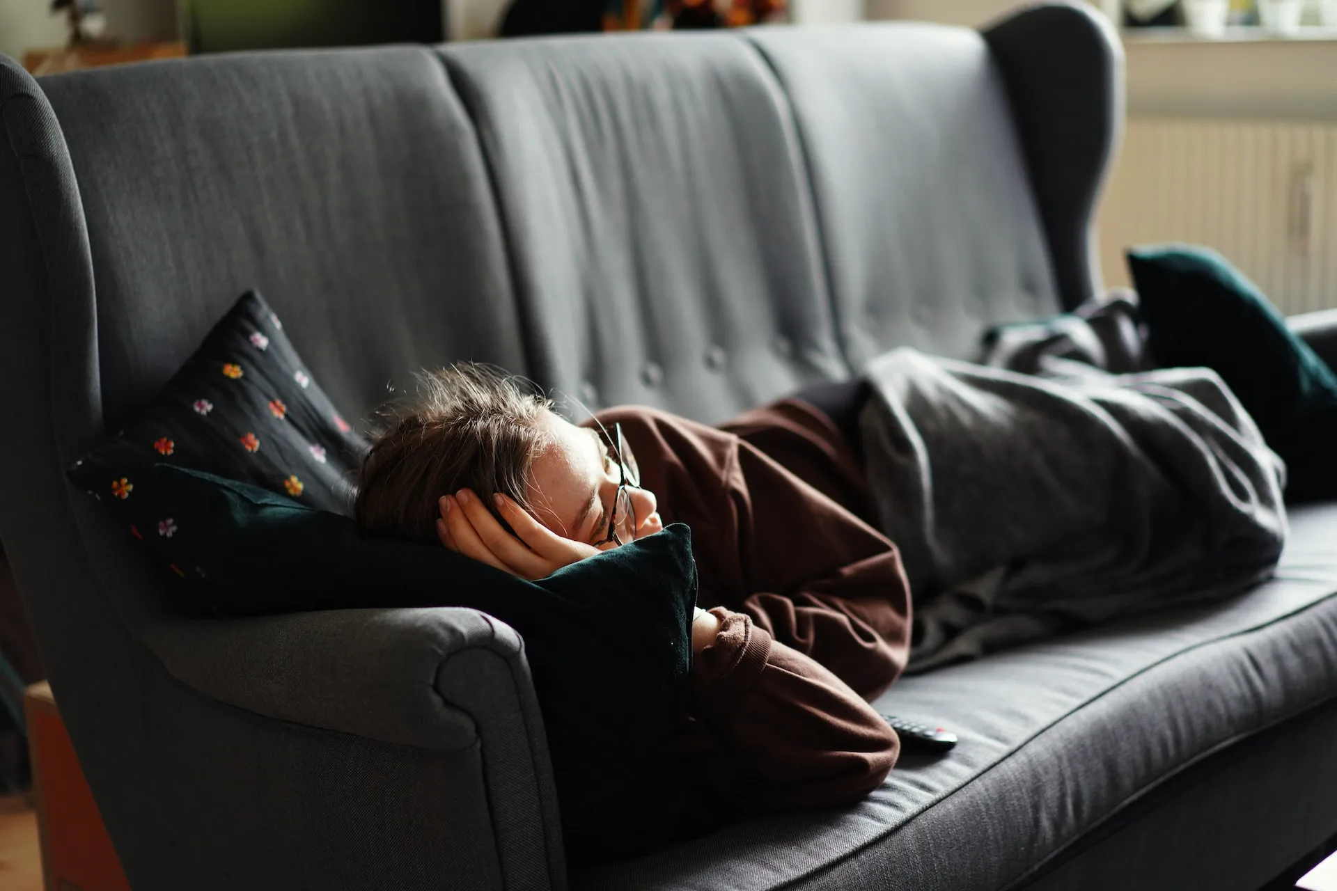 A young woman asleep on a couch