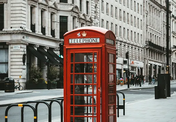 Traditional red telephone box on a street in Eastbourne, UK