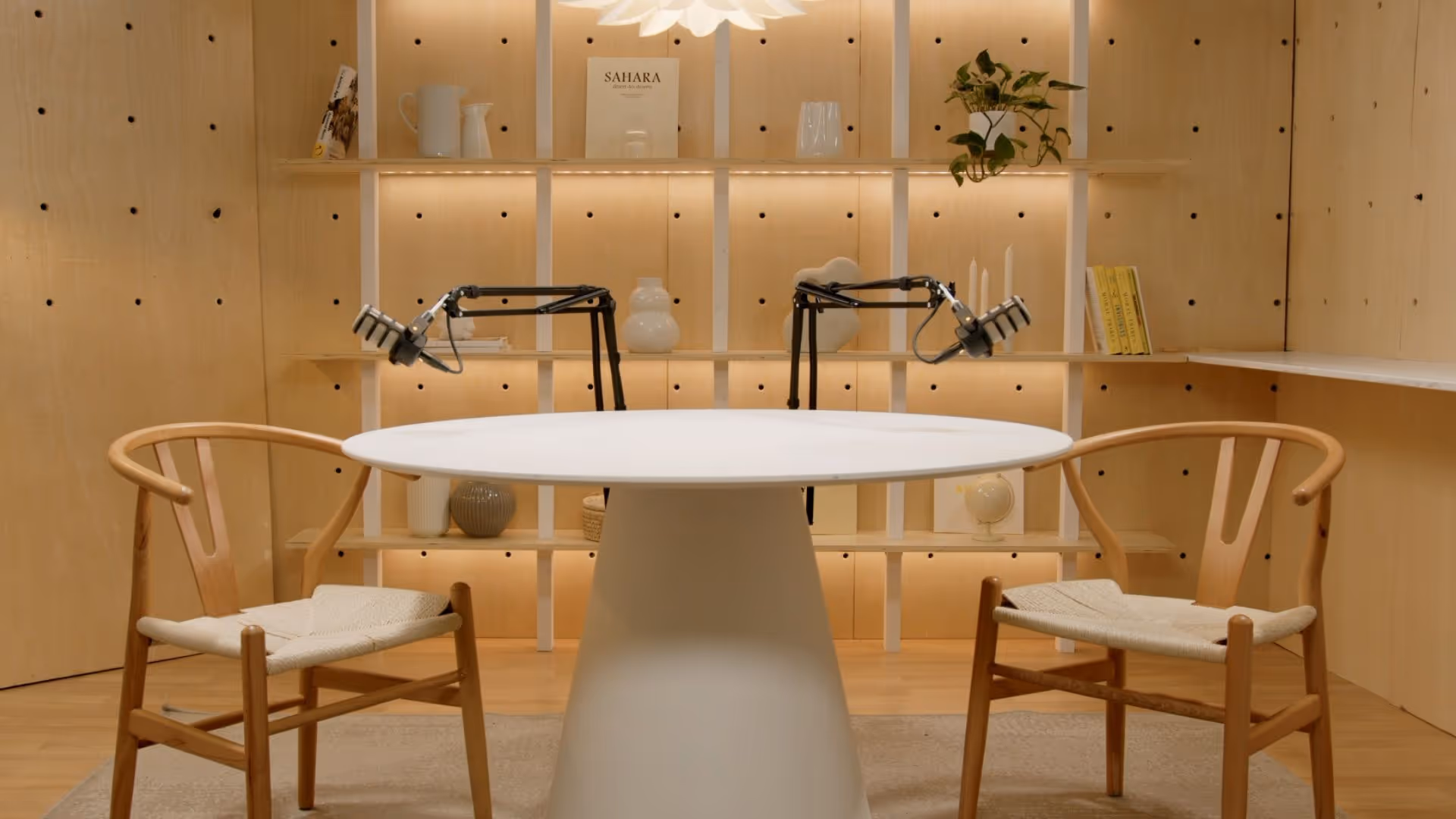 a table with chairs in front of a shelf
