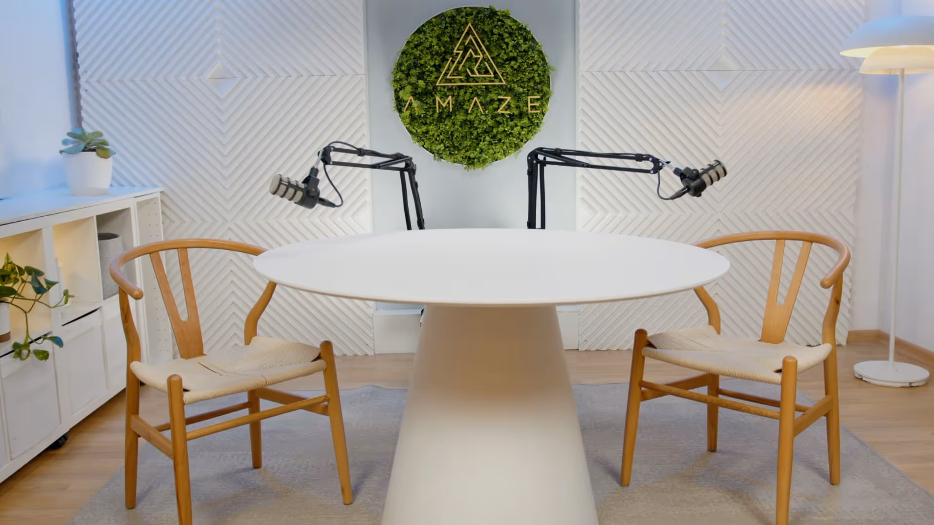 a white table with two chairs and a white table with a white wall behind it