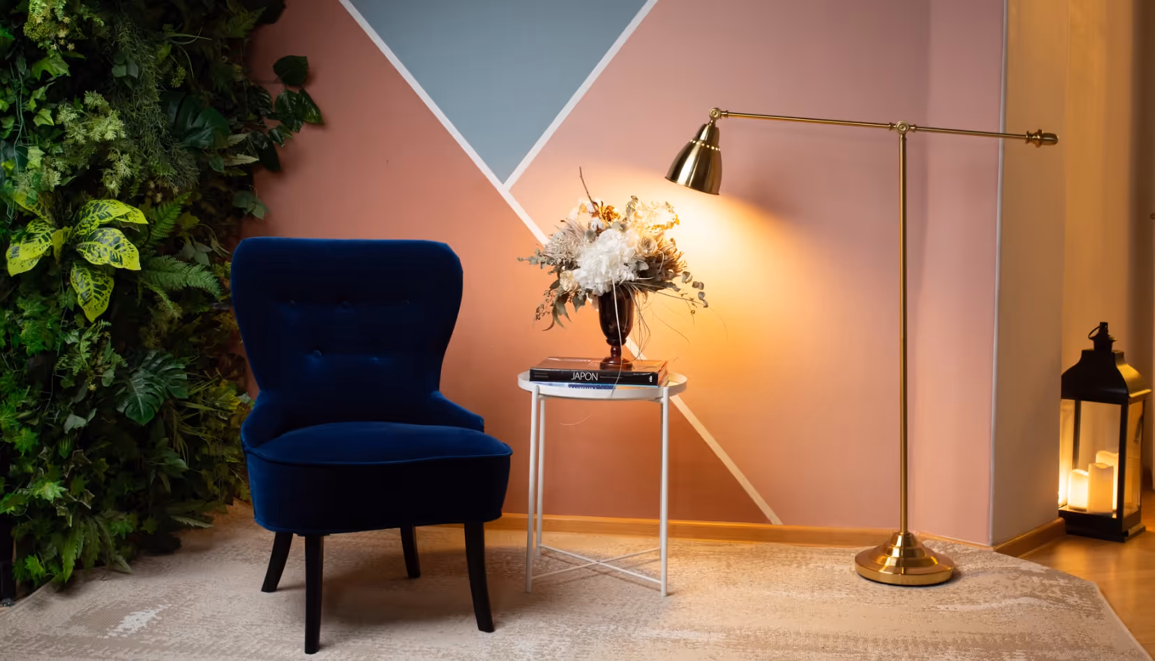 a blue chair next to a gold lamp