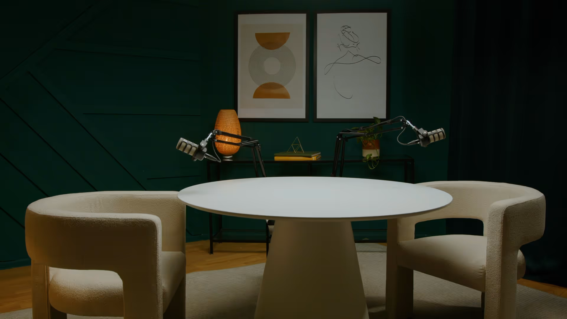 a white table with two chairs in a room with a green wall