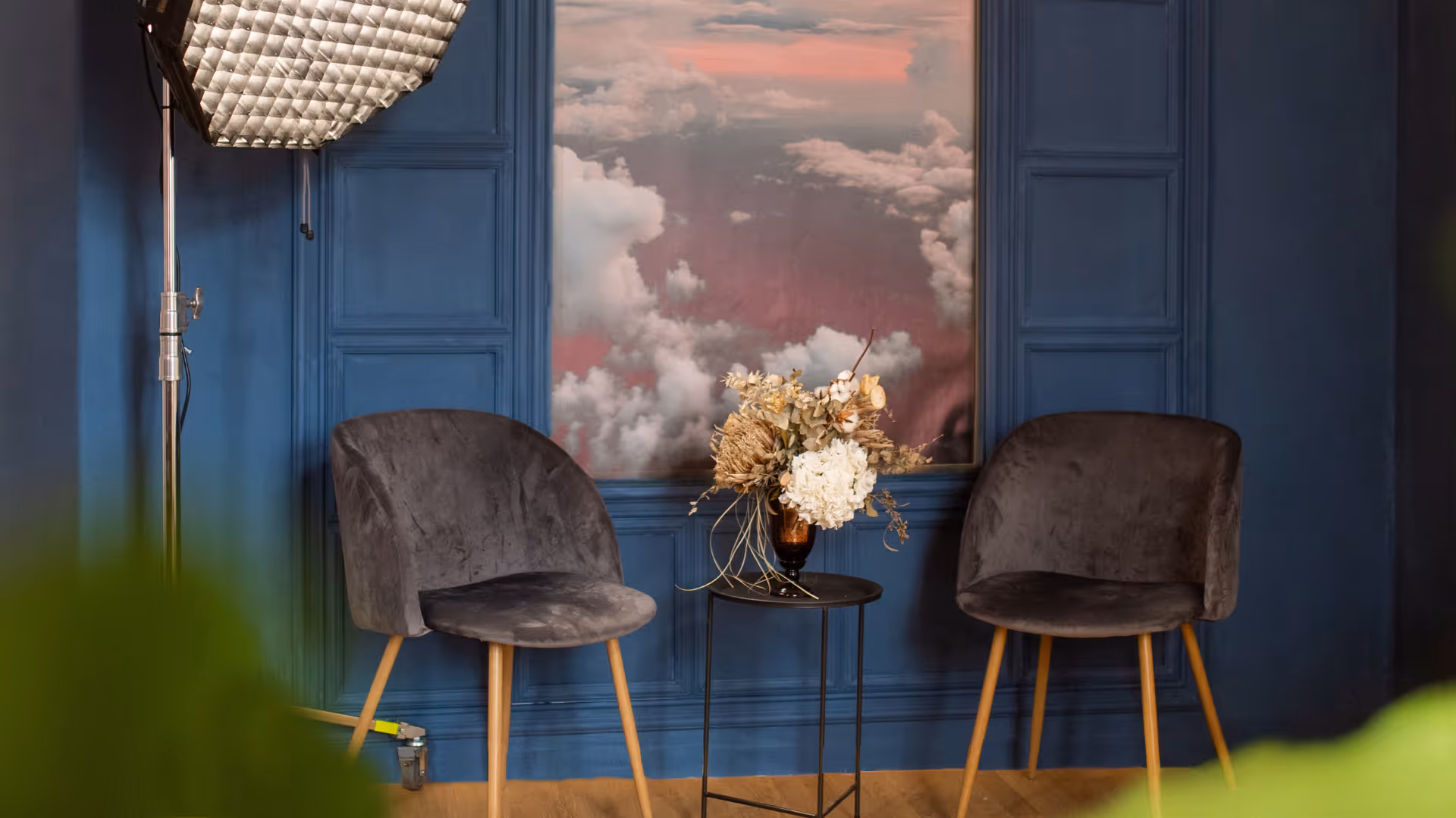 a room with chairs and a painting
