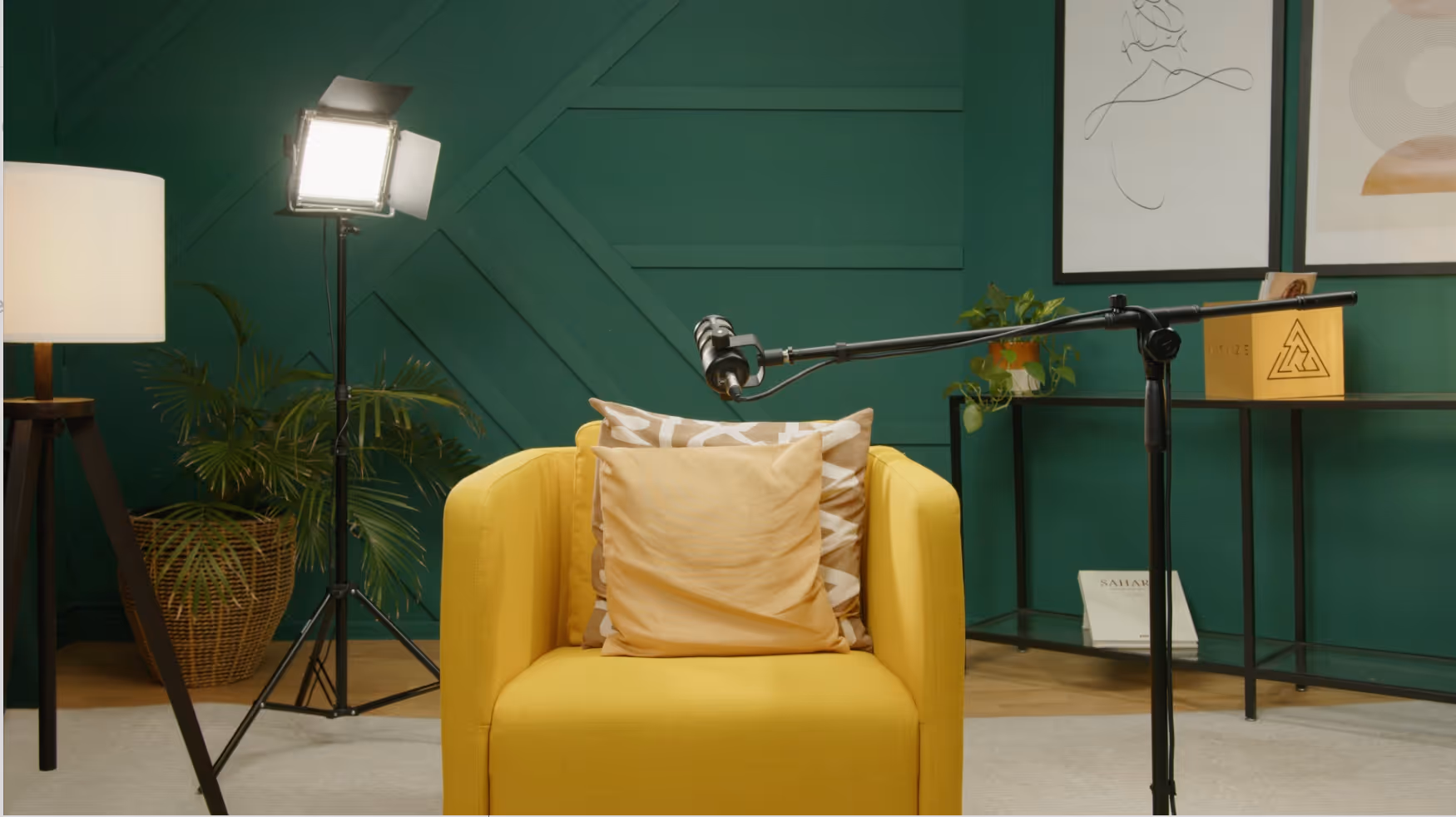 a yellow chair with a yellow pillow and a green wall
