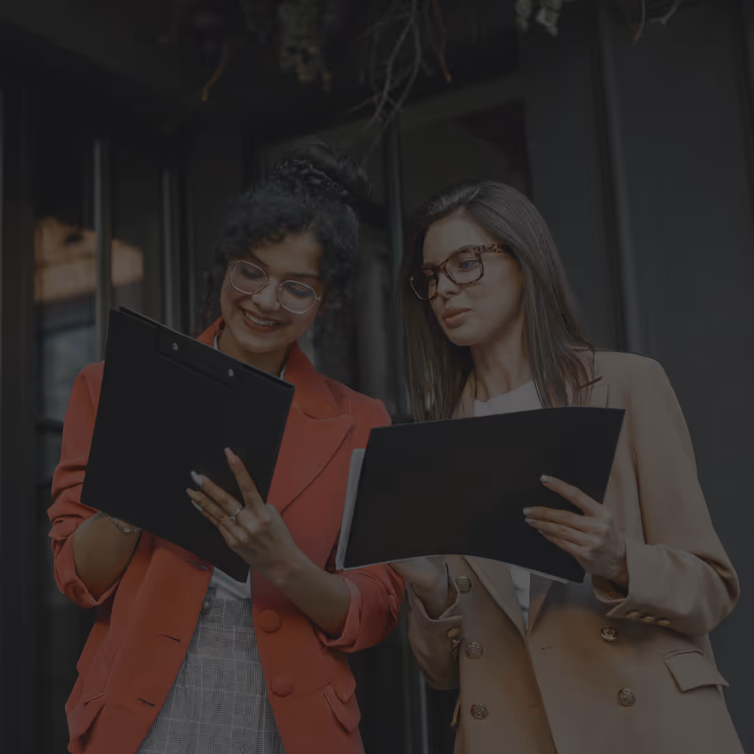 a couple of women looking at papers