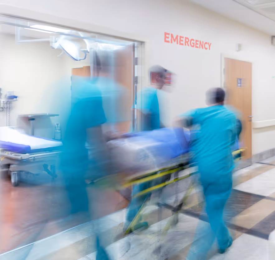 emergency room doctors wheeling patient blurred