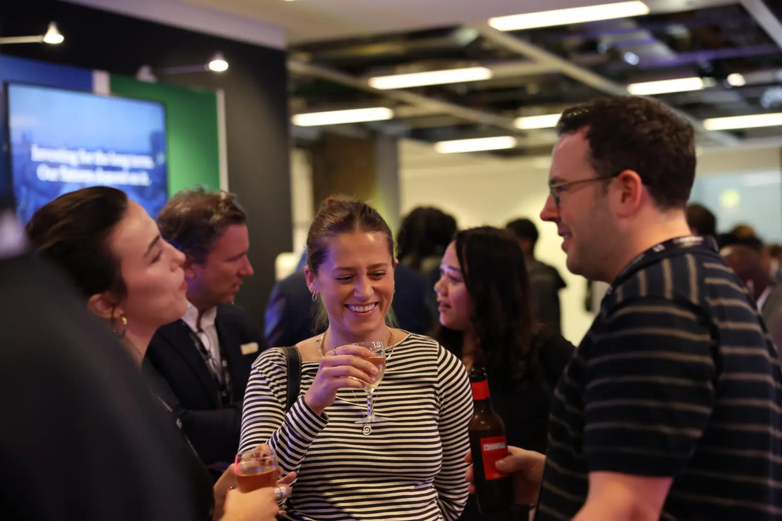 Attendees chatting over drinks