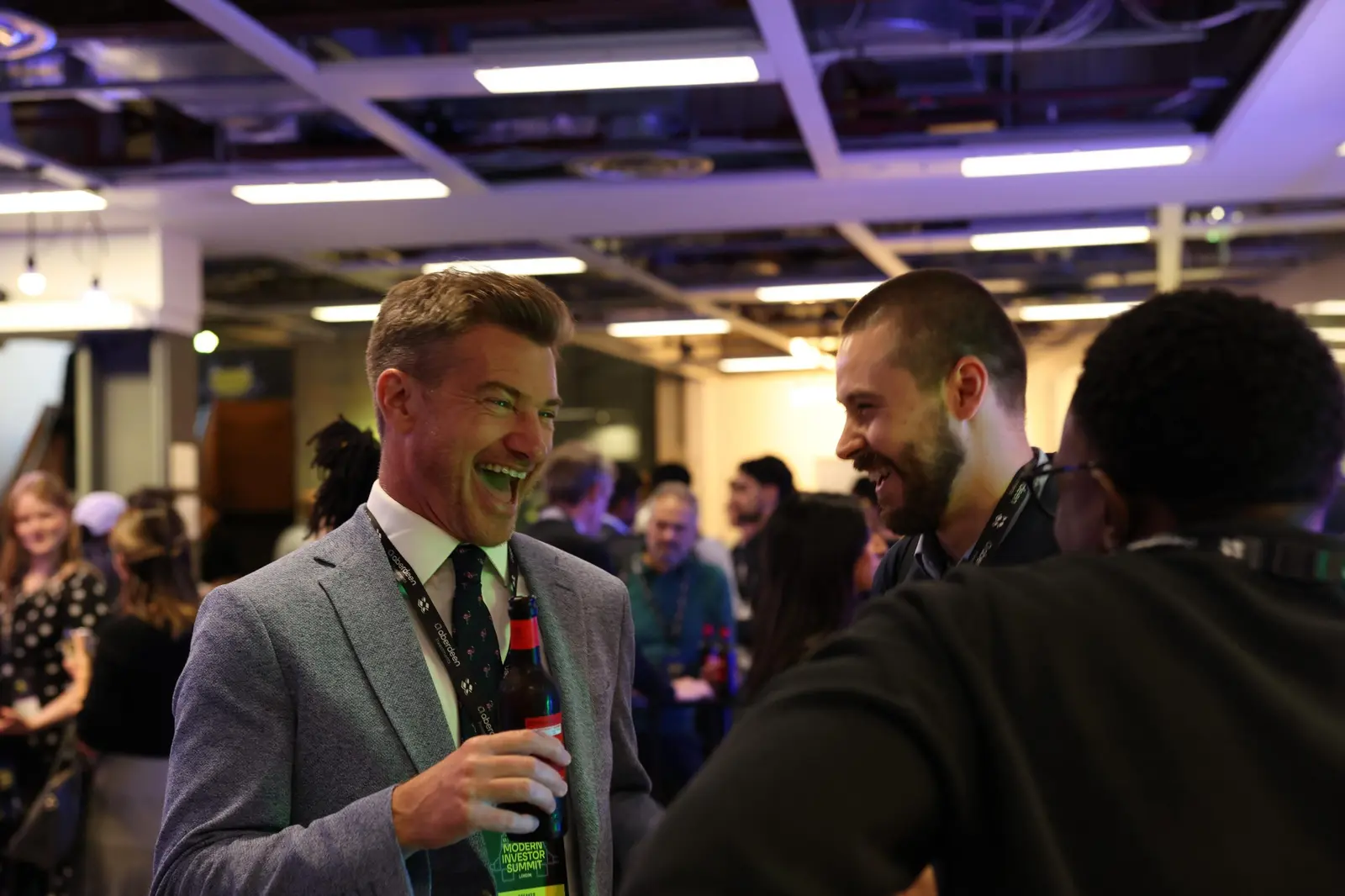 Two attendees sharing a laugh at the networking drinks