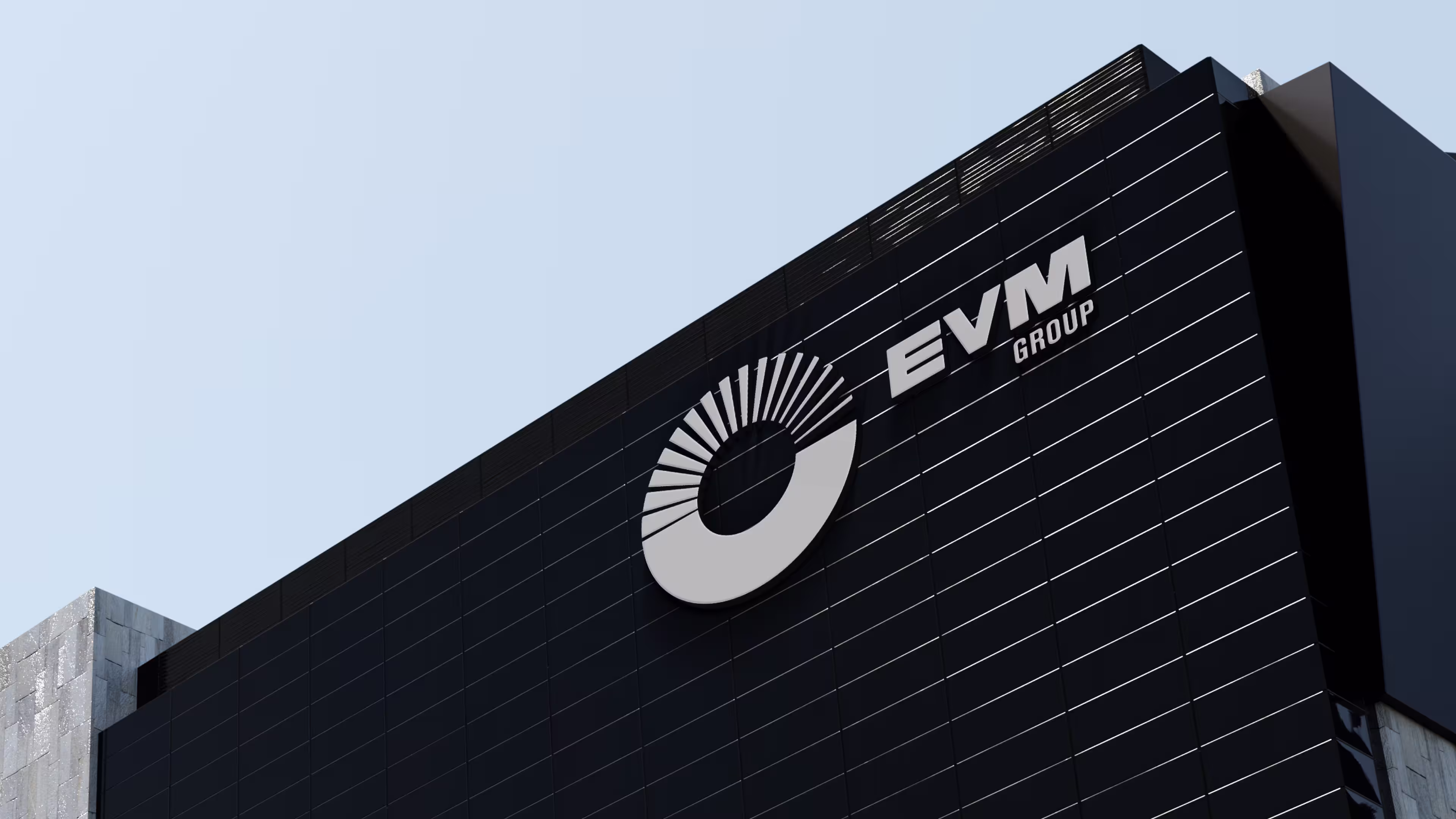 Black building facade with EVM Group logo and circular design in white on top corner.