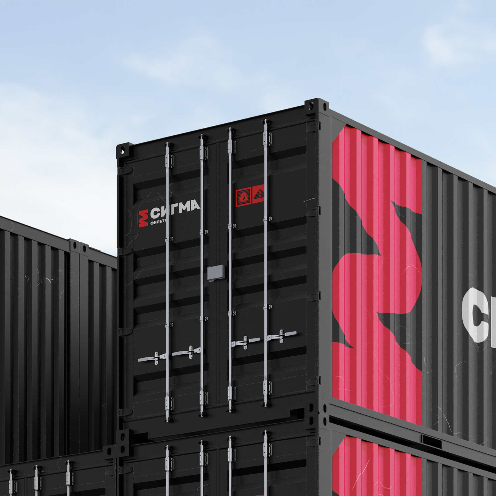 Stacked black shipping containers with red accents and Cyrillic text under a clear sky.