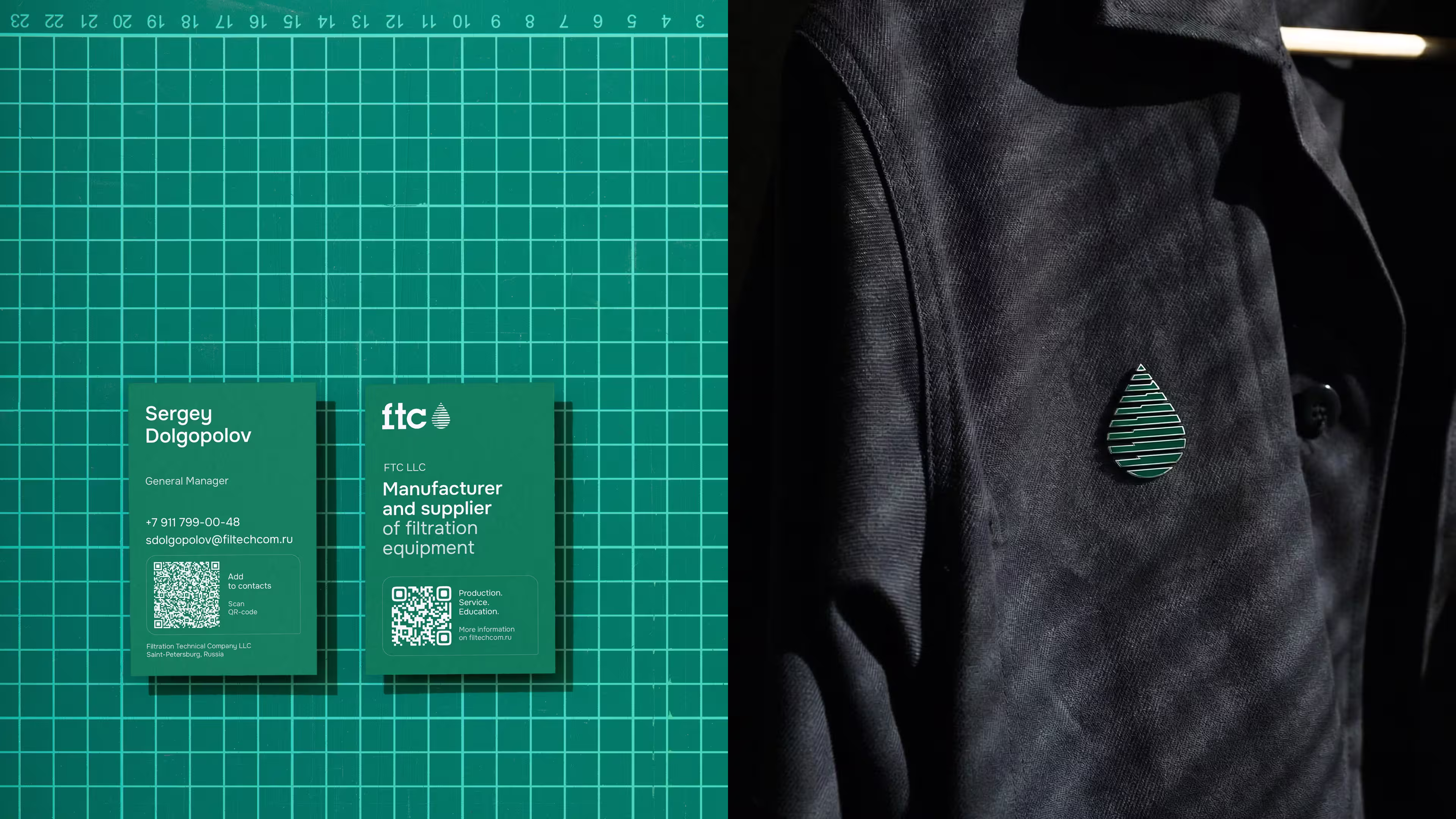 Two green business cards and a pin shaped like a striped water drop on a black jacket.