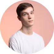 Portrait of a young man with light skin and brown hair wearing a white shirt against a pink background.