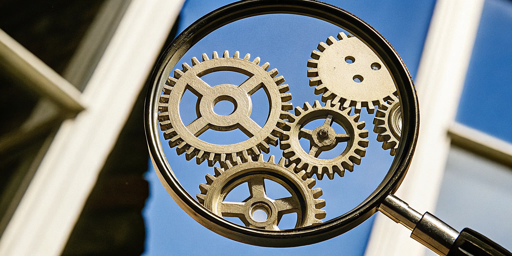 Agent vs. principal roles symbolized by interconnected gears under magnification.
