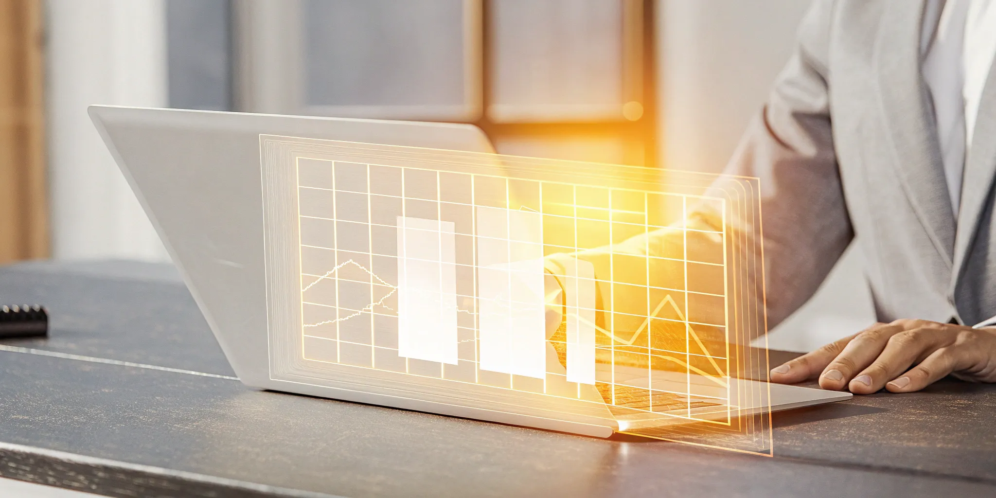 A professional analyzes financial graphs on a laptop, defining the process of accounting automation.