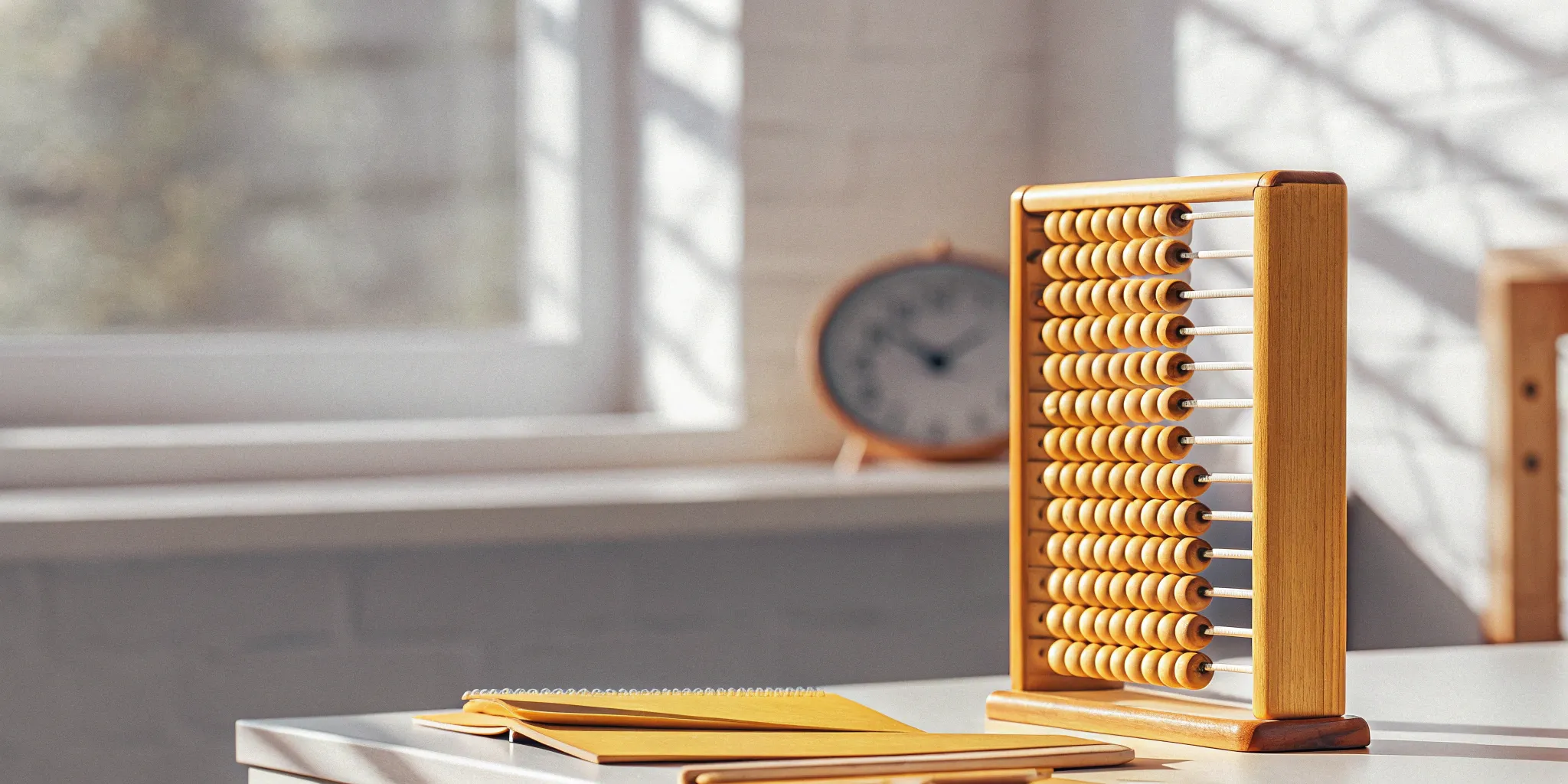 An abacus and notepad used for tracking the aging of accounts receivable.