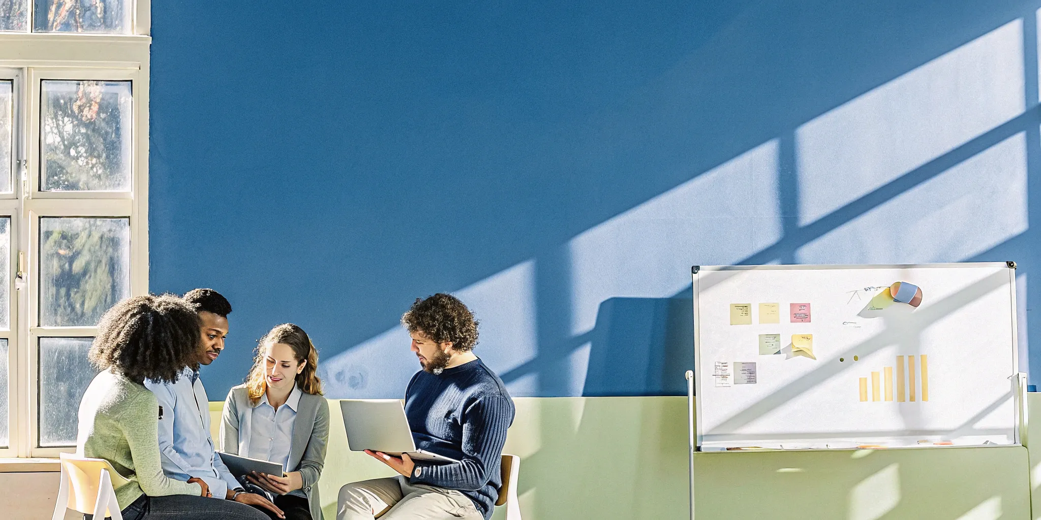 Team analyzing cohort retention data on a whiteboard.