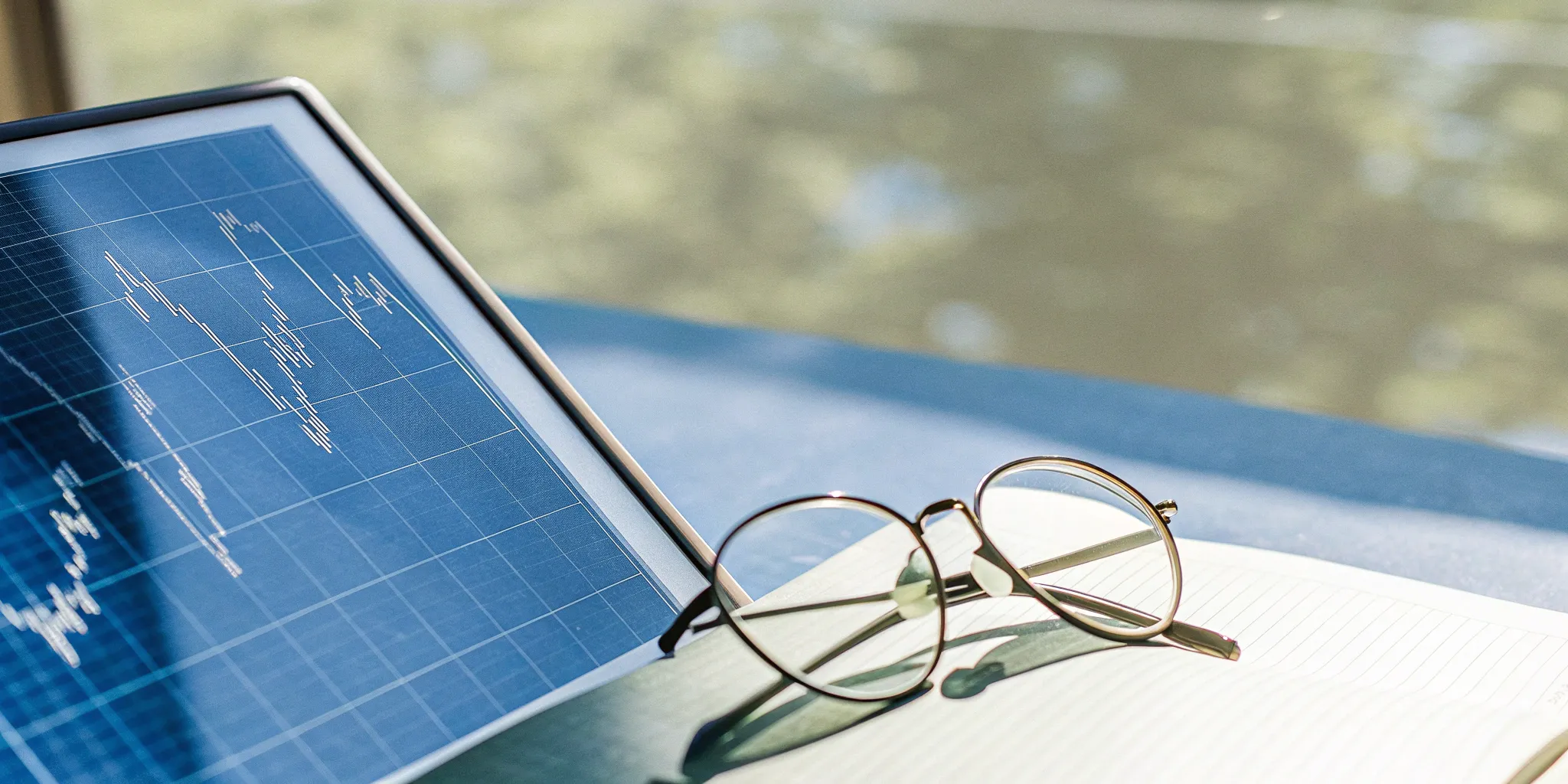 A tablet displaying an automated audit software dashboard with financial graphs.