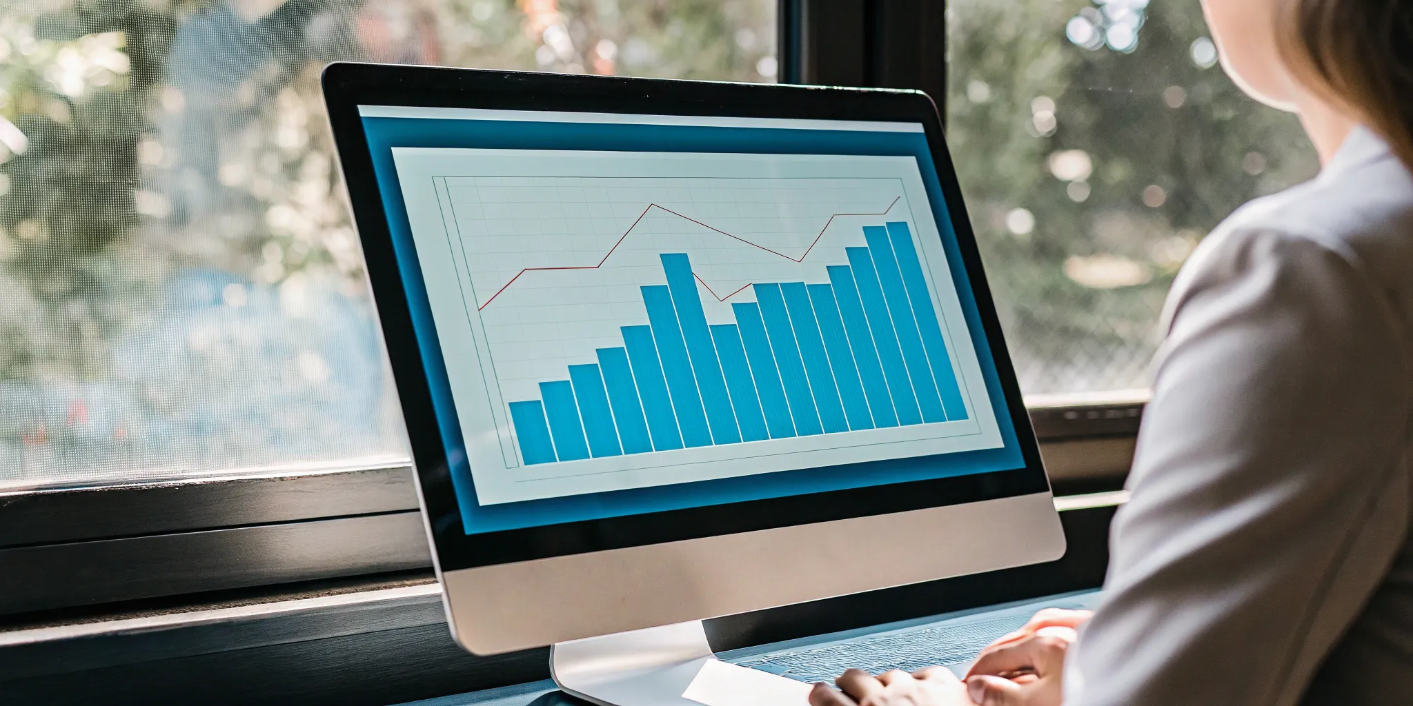 A person reviewing revenue recognition software analytics on a computer screen.