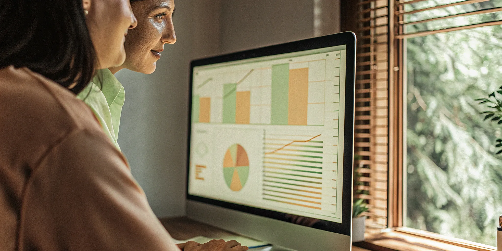 Analyzing recurring revenue charts on a computer for predictable income.