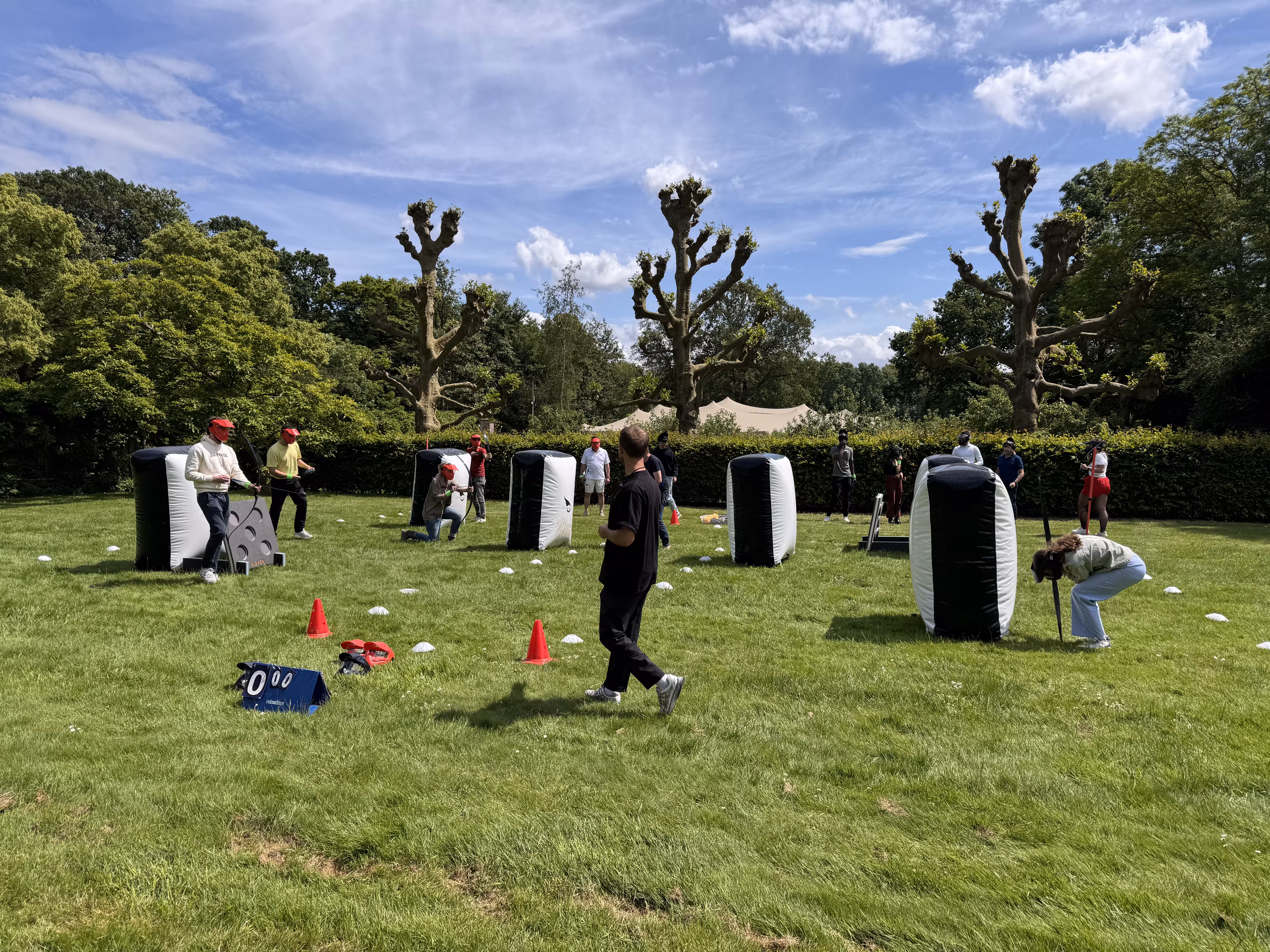 Opblaasbare objecten staan op het grasveld en de deelnemers schieten met pijl en boog