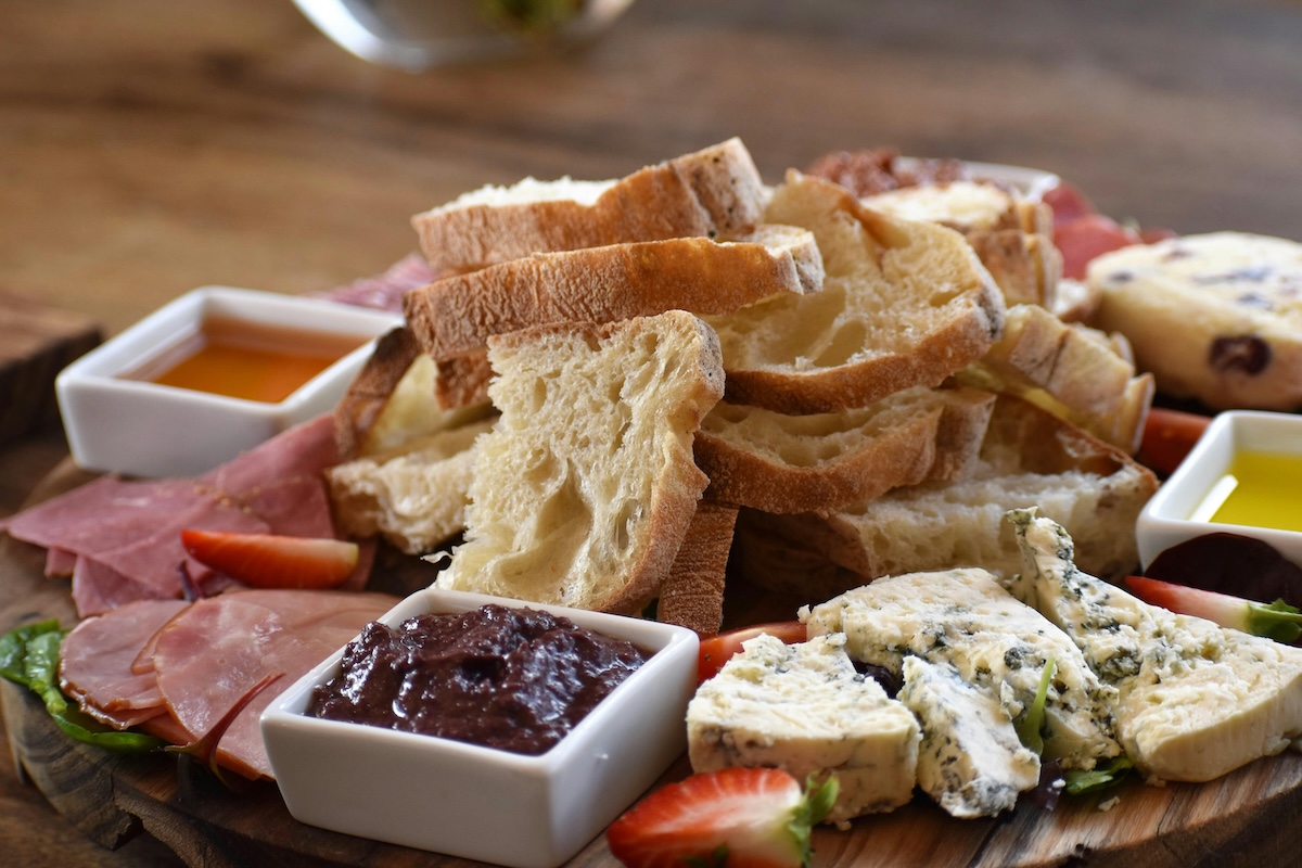 Delicious charcuterie plate of cured meat, cheeses, fruits, and bread at a luxury restaurant on Cape Cod in Massachusetts.