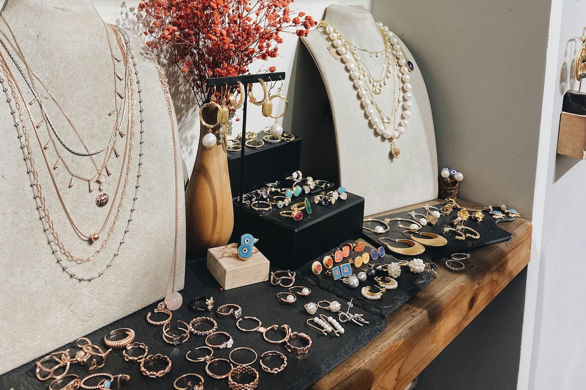 Showcase of necklaces, rings, and earrings in a stylish shop setting.
