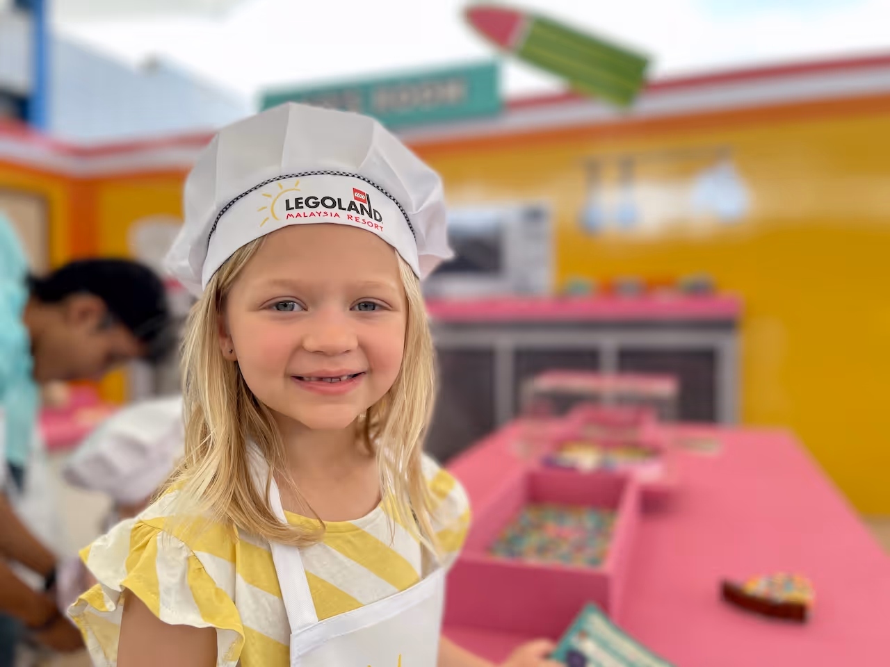 Lily in a chefs hat at legoland malaysia